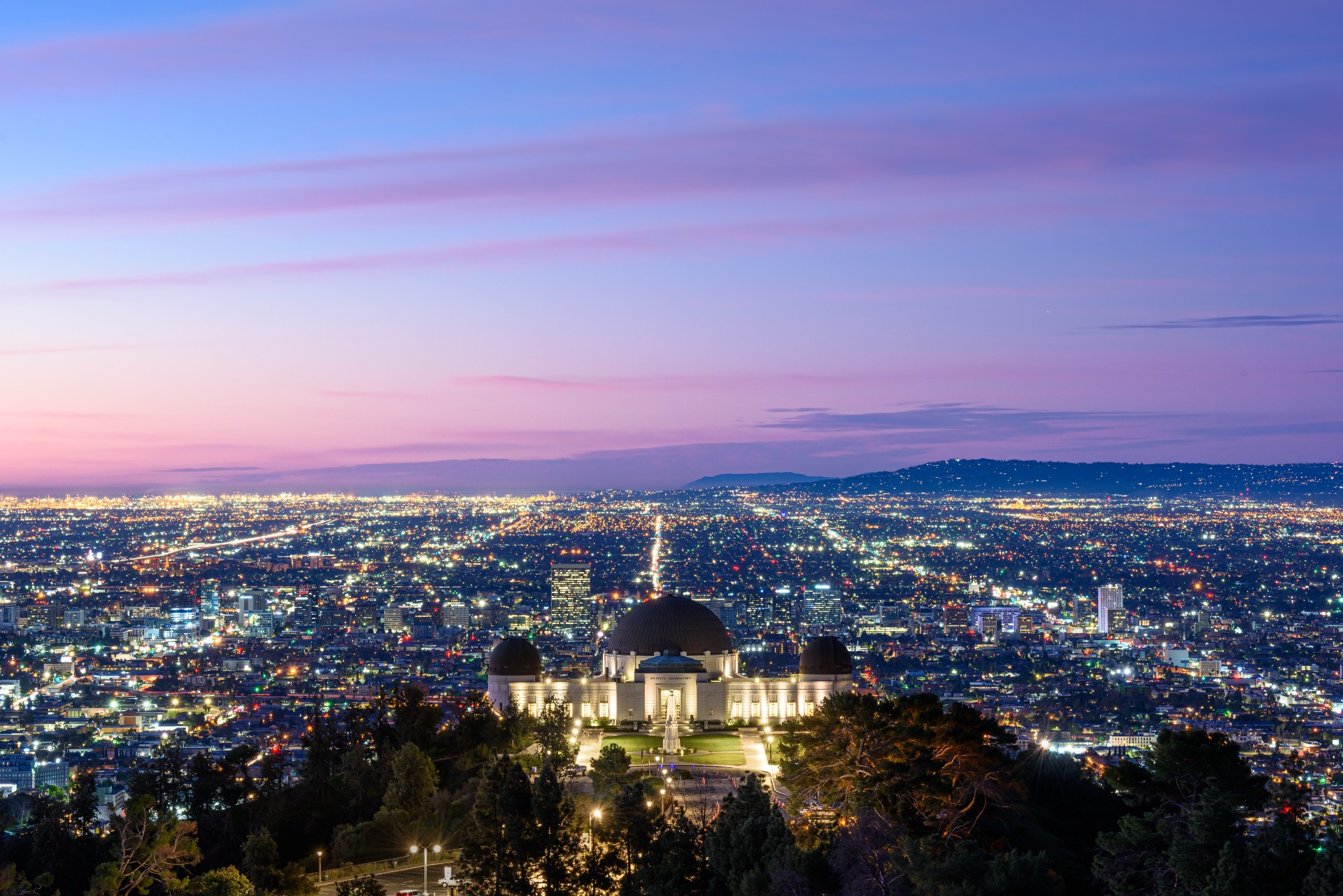 The Griffith Observatory above the Los Angeles skyline at dusk.